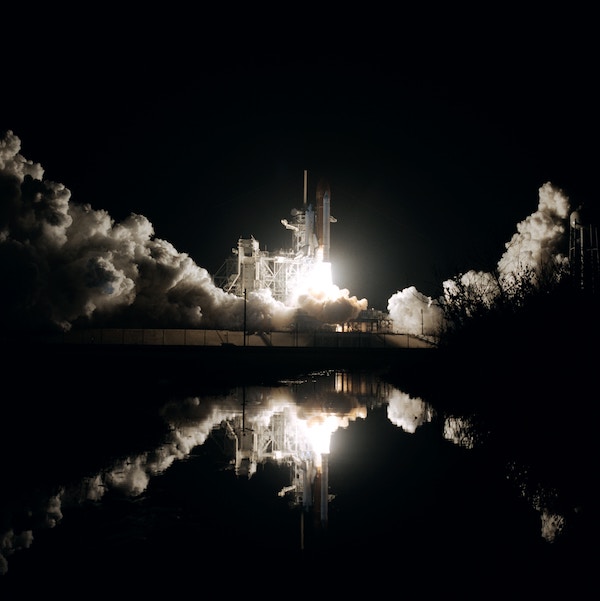 A spacecraft launches into the night sky